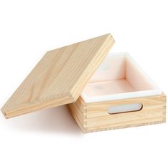 a wooden box with a white lid and handle on the inside that is open to show its contents