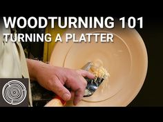 a man is holding a knife and fork over a plate that has food on it with the words woodturning 101 turning a platter