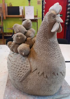 a clay sculpture of a chicken and her chicks