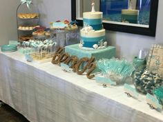 a table that has some cakes and desserts on it