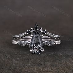 a black diamond ring sitting on top of a table