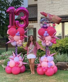 a woman is standing in front of balloons and letters that spell out the number 50