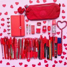 the contents of a valentine's day bag are laid out on a pink background