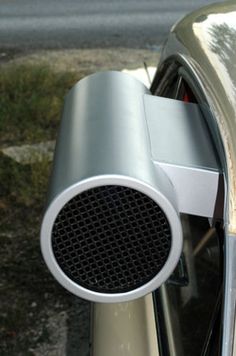 a close up of a car door handle with a speaker attached to the side of it