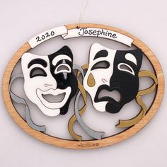 two masks that are on top of a wooden circle with the words josephime