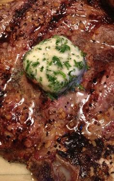 a piece of meat covered in gravy sitting on top of a plate