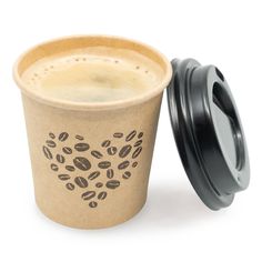 a coffee cup next to a black lid