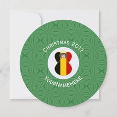 a round christmas card with the flag of belgium