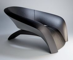 an unusual black and silver bench on a white background