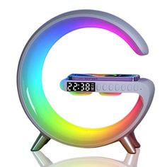 an alarm clock with the letter e on it's side and colorful lights around it