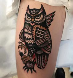 an owl tattoo on the thigh