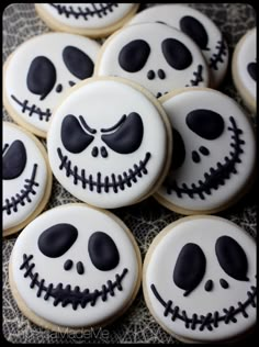 decorated cookies with black icing and white frosting are arranged in the shape of jack skellings