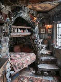 a bed in a room that looks like a log cabin with lots of wood and stone