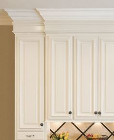 a kitchen with white cabinets and granite counter tops