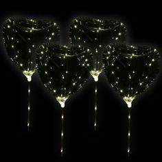 three light up wine glasses sitting next to each other