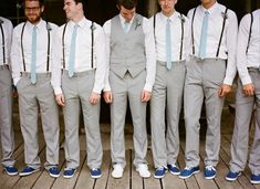 a group of men standing next to each other in front of a door wearing ties