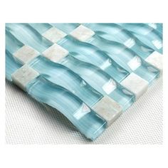 a blue and white checkerboard design glass tile on a wall or table top