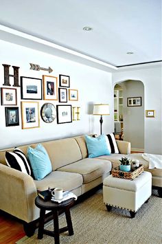 a living room filled with furniture and pictures on the wall