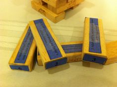 four wooden blocks sitting on top of a bed