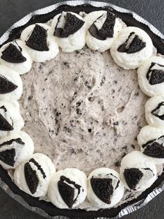 an oreo cookie and cream pie is shown in a pie pan on a table