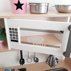 a white microwave oven sitting on top of a wooden counter