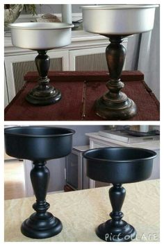 two black candlesticks sitting on top of a table