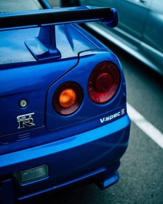 the rear end of a blue sports car