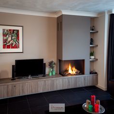 a living room filled with furniture and a fire place next to a flat screen tv