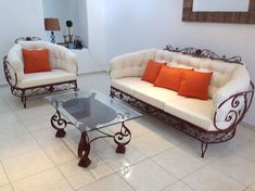 two couches and a coffee table in a room with tile flooring on the floor