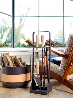 a wooden chair sitting next to a firewood log holder on top of a hard wood floor