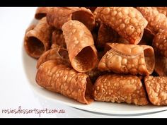 a white plate topped with croissants covered in sauce