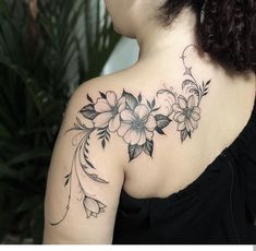 a woman with a flower tattoo on her shoulder