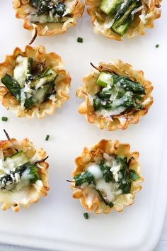 small appetizers with spinach and cheese on a white tray