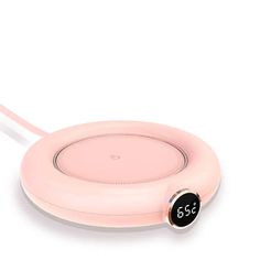 an alarm clock is shown on the side of a pink object with a white background