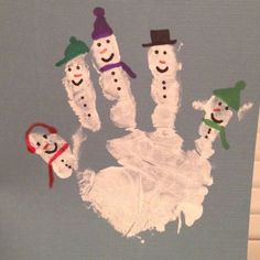 a hand made out of paper with snowmen on it