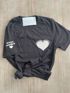 Unisex adult t-shirt in 100% soft cotton. Heart with I wear my heart on my sleeve around it on left side of chest. Names and heart on right sleeve. Don't see a color you want as an option? Reach out to us and we will be sure to try our best and fulfil your request. Live chat us directly on our site, dm us on Instagram, email us at cheeksandbubbles@gmail.com THIS ITEM GETS FREE ECONOMY SHIPPING! Care instructions - For best results wash inside out in cold water and tumble dry low. Cotton Graphic Tee With Heart Patch, Heart On My Sleeve, Live Chat, Tumble Dryer, Shirt Sleeves, Inside Out, Cold Water, My Home, Care Instructions