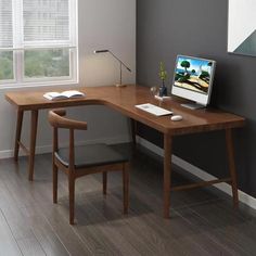 a computer desk with a laptop on top of it next to a chair and window