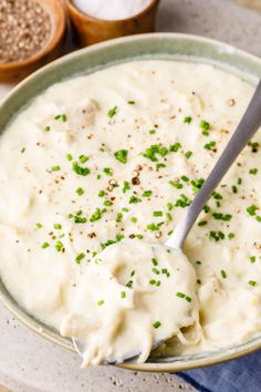 a bowl filled with mashed potatoes and garnished with chives