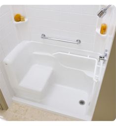 a white bath tub sitting next to a shower stall with yellow towels on the wall