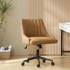 a brown office chair sitting on top of a hard wood floor next to a white dresser