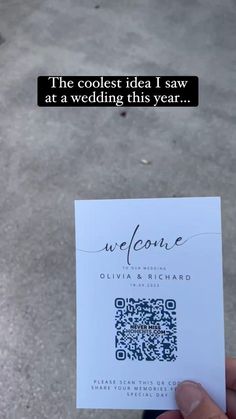 someone is holding up a card that says welcome to their wedding day and it has a qr code on it