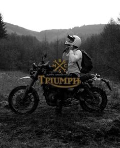 a black and white photo of a person sitting on a motorcycle with the words triumph