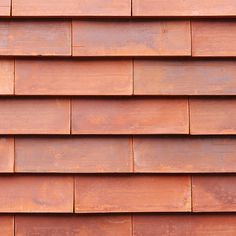 a close up view of the side of a building with red shingles on it