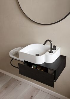 a bathroom sink sitting on top of a wooden counter