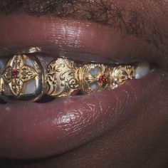 Dusaint Duvel on Instagram: "Inspired by designs on stained glass in churches 14k yellow gold set in red diamonds for Hurri 🦷#dusaint #grillz" Grillz Teeth, Chunky Gold Jewelry, Xoxo Jewelry, Diamond Grillz, Gold Grill, Red Diamonds, Streetwear Jewelry, Gold Grillz, Earthy Jewelry