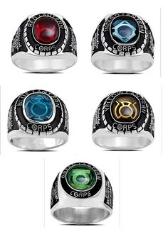 four rings with different colors and designs on them, all in the same ring size