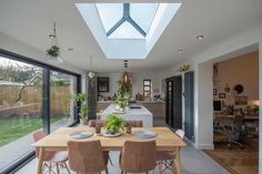 an open kitchen and dining room with skylights