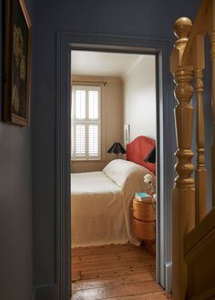 an open door leading to a bedroom with a bed