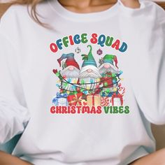 "Office Staff Christmas Shirt makes the perfect shirt for the School Office or Admin crew fthis holiday season! T-shirt: This is made with a Gildan 64000 unisex soft-style t-shirt. Made from very soft materials, this tee is 100% cotton for solid colors. Heather colors and sports grey include polyester. The shoulders have twill tape for improved durability. There are no side seams. The collar is made with ribbed knitting to prevent curling damage. *100% ring-spun cotton *Light fabric *Tear-away l Office Team, Office Staff, Holiday Apparel, The Office Shirts, Squad Shirt, Christmas 2024, Christmas Mugs, School Office, Cotton Lights