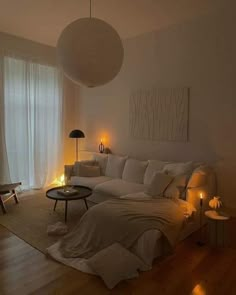 a living room filled with lots of white furniture